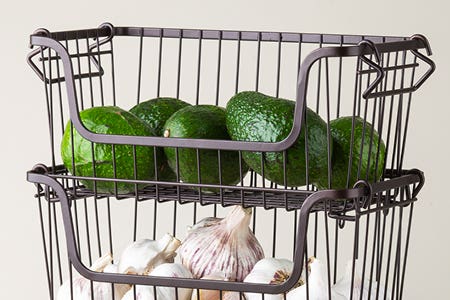 stacked wire baskets with avocados and garlic