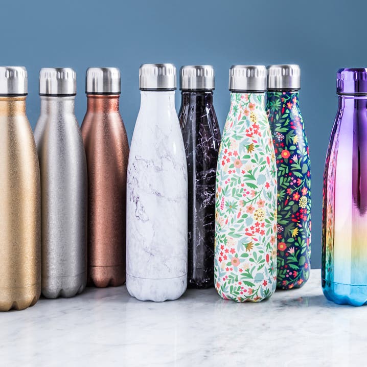 various different coloured water bottles on a marble countertop