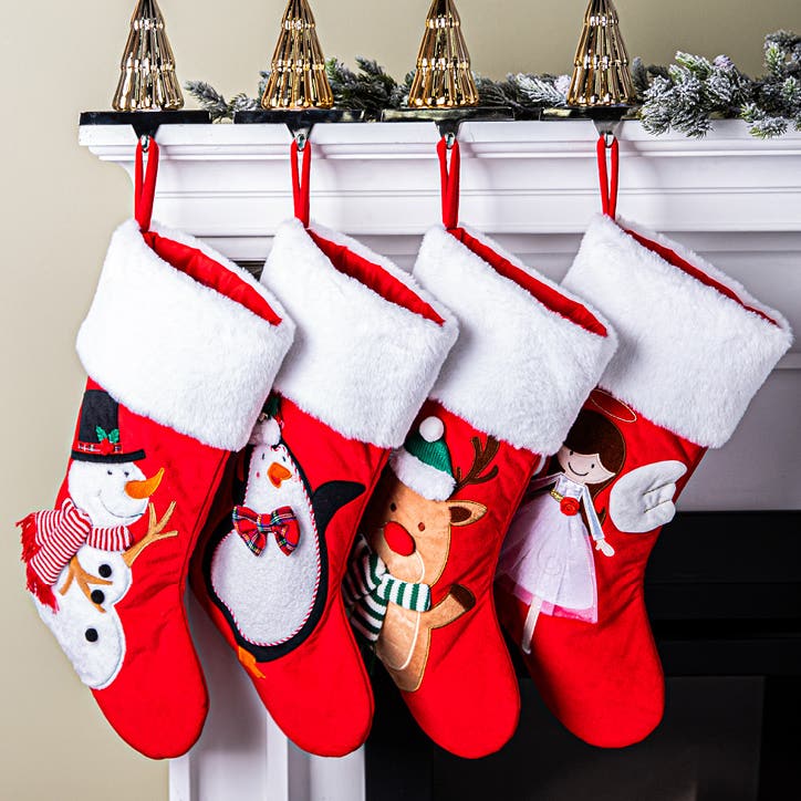 4 stockings hanging on a fireplace mantel