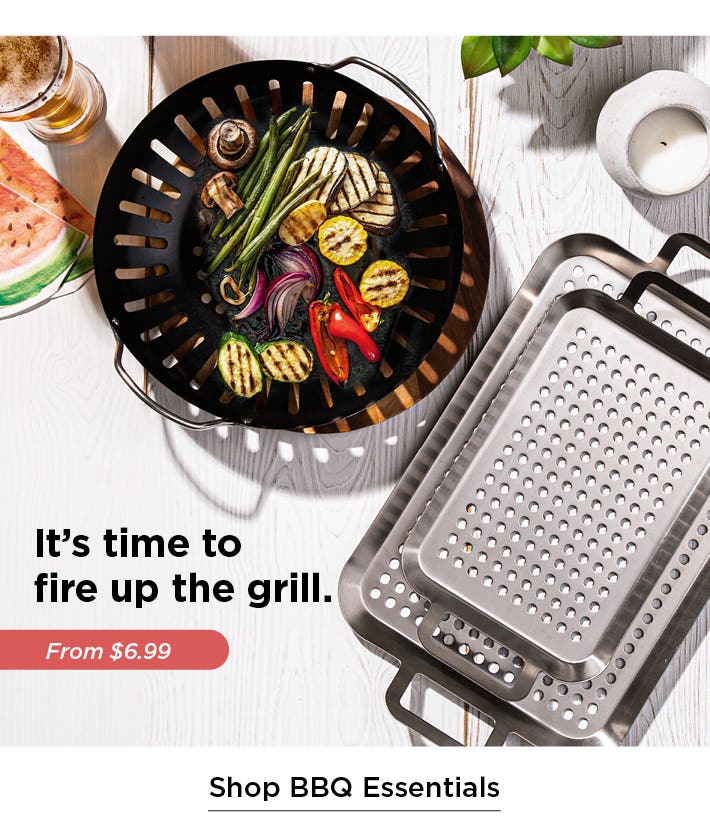 overhead view of tabletop with BBQ grilling pans, one with grilled vegetables - it's time to fire up the grill