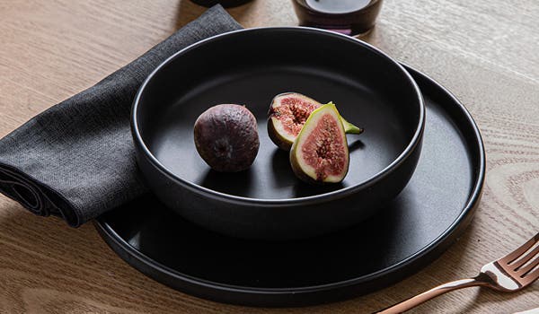 place setting using matte black bowl and plate on a wooden table top for mobile