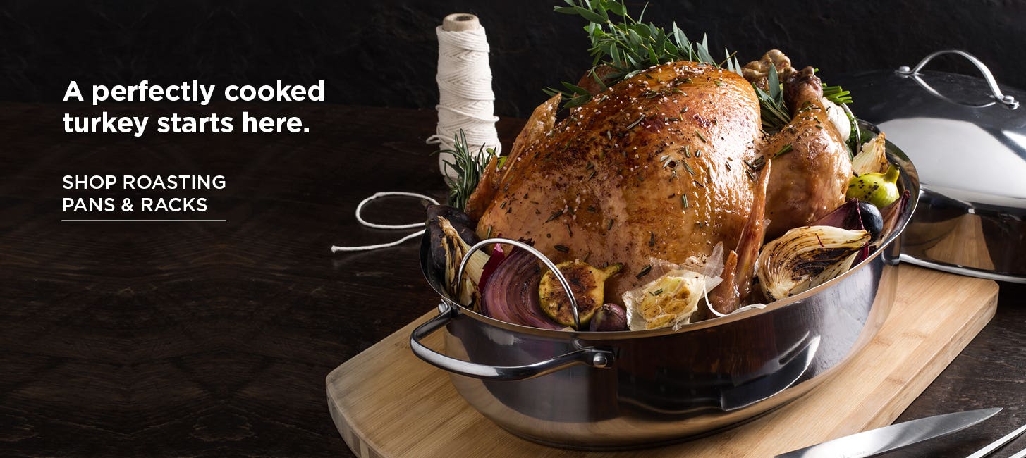 Turkey in a roasting pan, on a cutting board with twine and a slicing knife